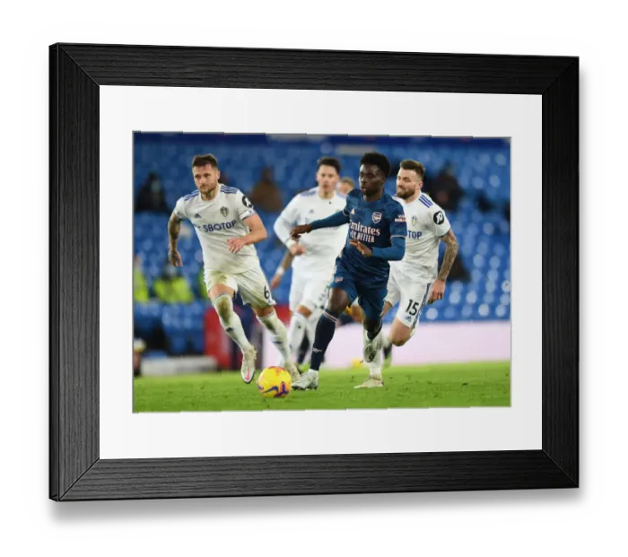 Framed Print : Bukayo Saka Clashes with Leeds Defenders: Arsenal vs Leeds United, Premier League 2020-21