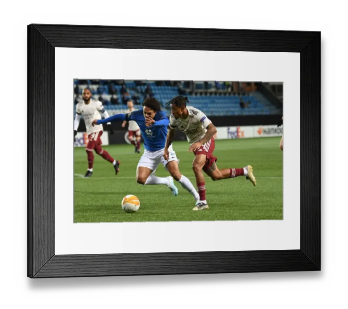 Framed Print : Arsenal's Reiss Nelson Faces Off Against Molde's Henry Wingo in Europa League Clash Framed Print : Arsenal's Reiss Nelson Faces Off Against Molde's Henry Wingo in Europa League Clash