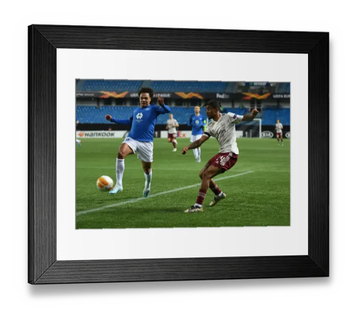 Framed Print : Reiss Nelson Faces Off Against Henry Wingo: Molde FK vs. Arsenal FC - UEFA Europa League (Group B) Framed Print : Reiss Nelson Faces Off Against Henry Wingo: Molde FK vs. Arsenal FC - UEFA Europa League (Group B)