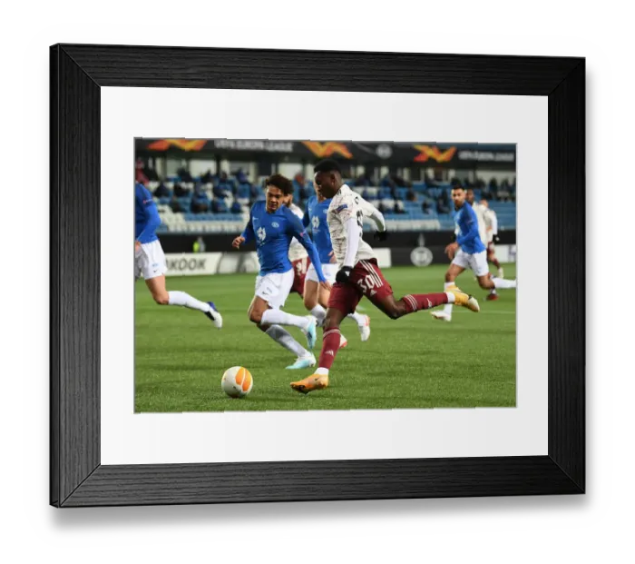 Framed Print : Arsenal's Eddie Nketiah Faces Off Against Molde's Henry Wingo in Europa League Clash Framed Print : Arsenal's Eddie Nketiah Faces Off Against Molde's Henry Wingo in Europa League Clash