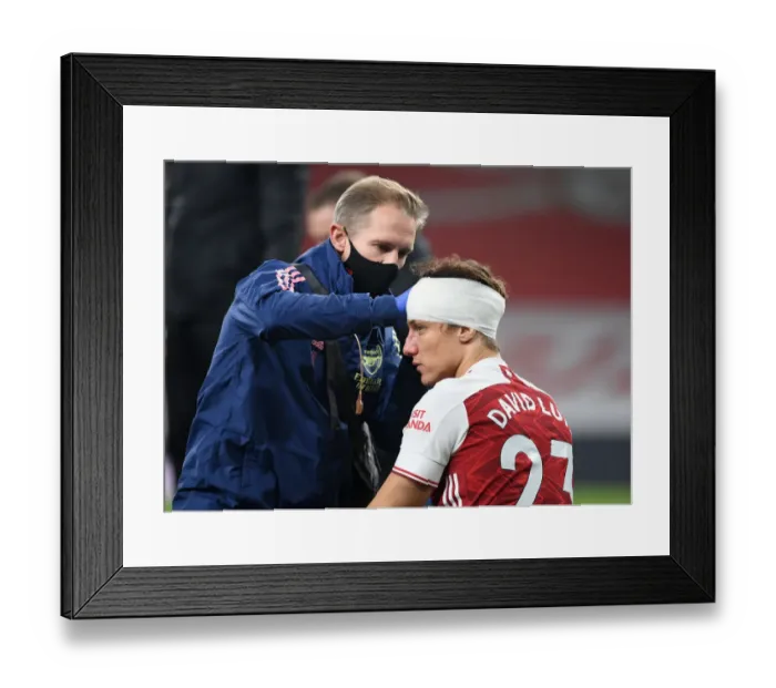 Framed Print : Arsenal's David Luiz Receives Solo Head Injury Treatment in Empty Emirates Stadium (Premier League, 2020-21)