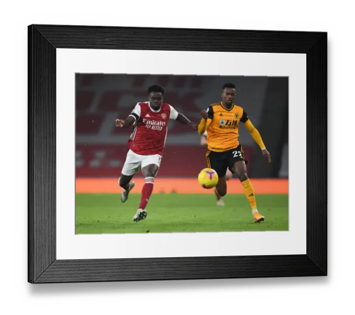 Framed Print : Bukayo Saka vs. Nelson Semedo: A Battle at Empty Emirates - Arsenal vs. Wolverhampton Wanderers (Premier League 2020-21)