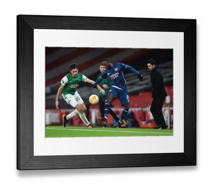 Framed Print : Arsenal's Nicolas Pepe Faces Off Against Rapid Wien's Leo Greiml in Empty Emirates Stadium - UEFA Europa League 2020-21