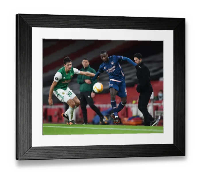 Framed Print : Arsenal's Pepe Faces Off in Empty Emirates: A UEFA Europa League Showdown against Rapid Wien, 2020