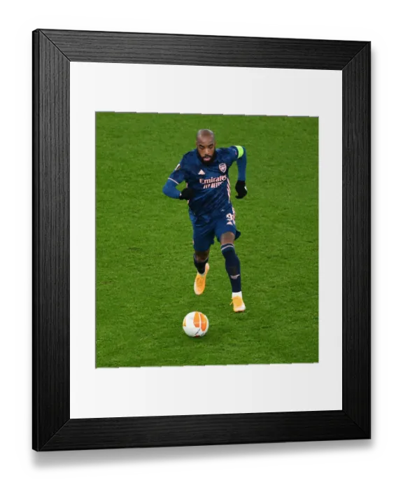 Framed Print : Alexis Lacazette Plays Alone: Arsenal's Emirates Emptied for Europa League Clash Against Rapid Wien