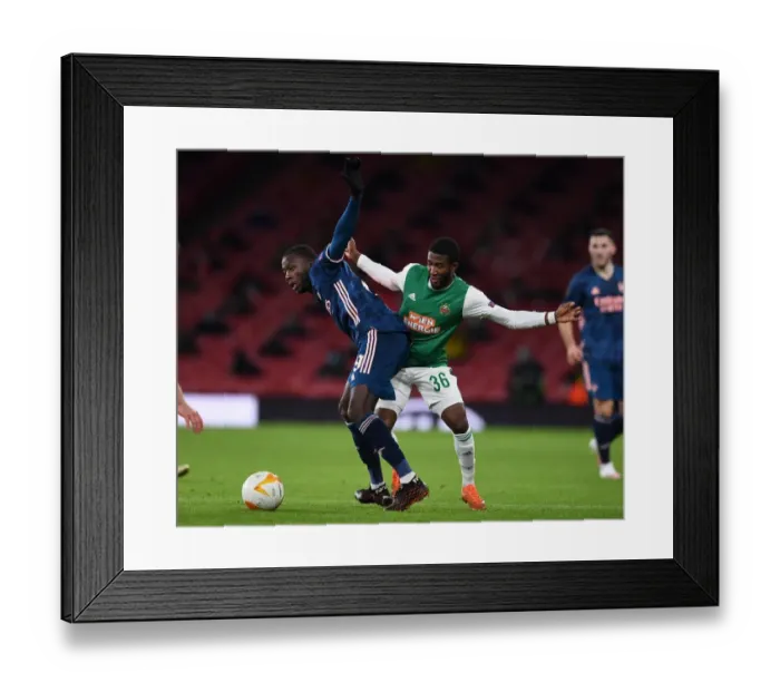 Framed Print : Arsenal's Nicolas Pepe Clashes with Rapid Wien's Kelvin Arase in Europa League Showdown