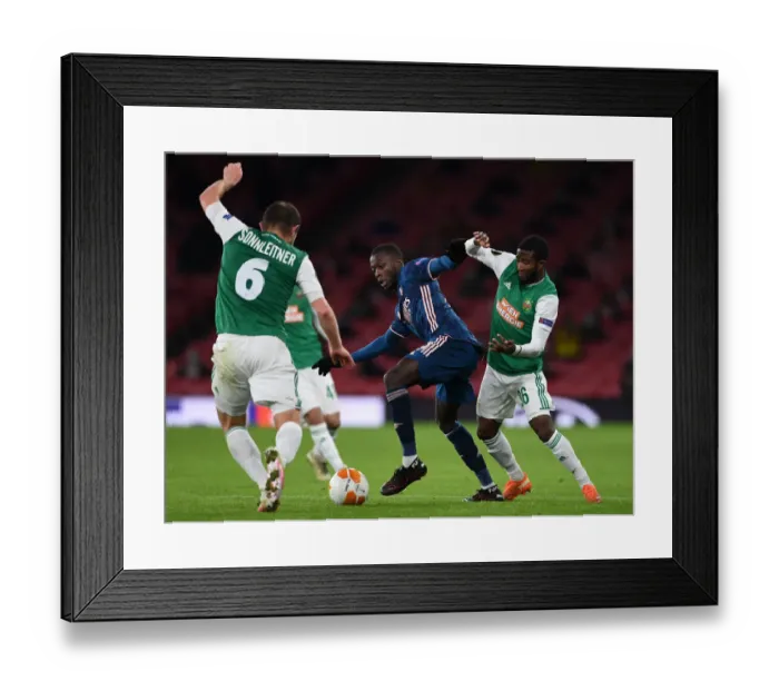 Framed Print : Arsenal's Nicolas Pepe Faces Off Against Rapid Wien's Kelvin Arase in Europa League Clash Framed Print : Arsenal's Nicolas Pepe Faces Off Against Rapid Wien's Kelvin Arase in Europa League Clash