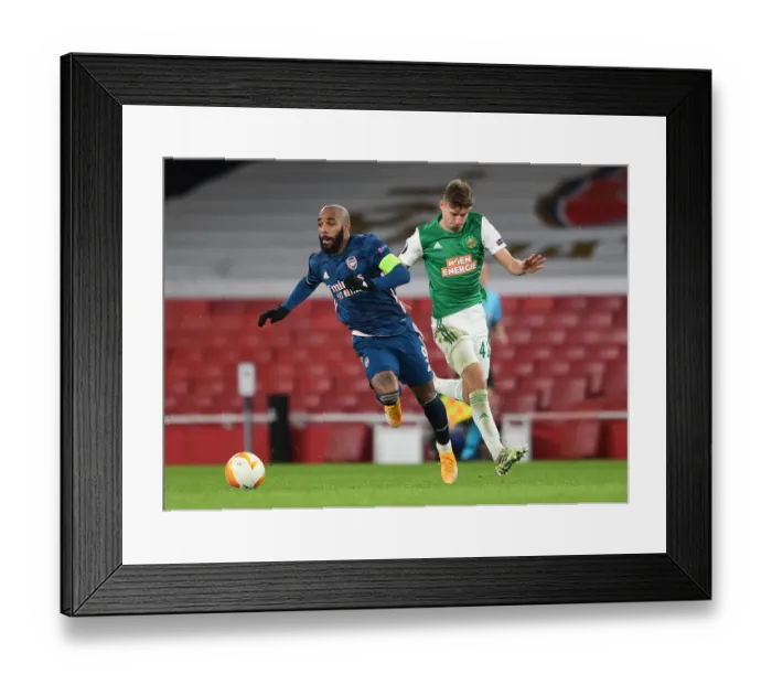 Framed Print : Arsenal's Lacazette Faces Off Against Rapid Wien's Schuster in Europa League Clash Framed Print : Arsenal's Lacazette Faces Off Against Rapid Wien's Schuster in Europa League Clash