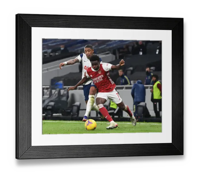 Framed Print : Saka Stands Strong: Bukayo Faces Off Against Bergwijn and Aurier in Intense Arsenal-Tottenham Showdown, 2020-21 Premier League