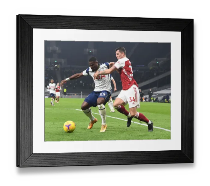 Framed Print : Granit Xhaka vs. Serge Aurier: Clash of the London Rivals in the Premier League