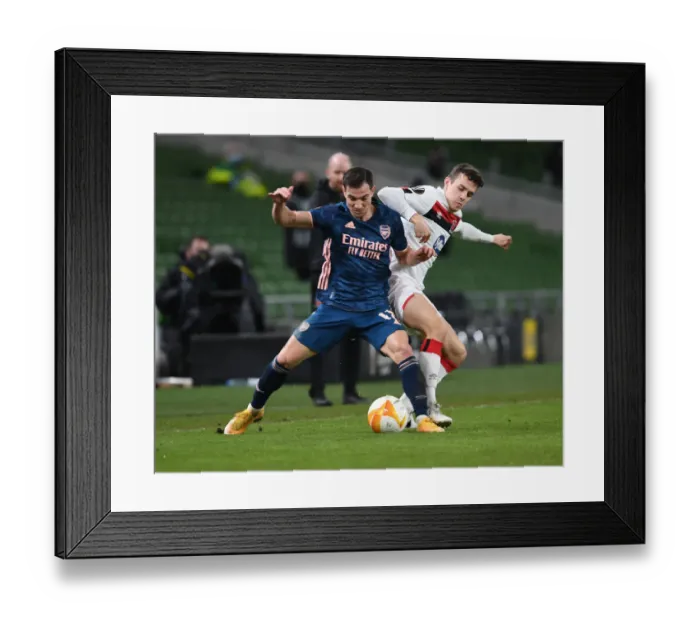 Framed Print : Arsenal's Cedric Breezes Past Dundalk's James Wynne in UEFA Europa League Clash Framed Print : Arsenal's Cedric Breezes Past Dundalk's James Wynne in UEFA Europa League Clash