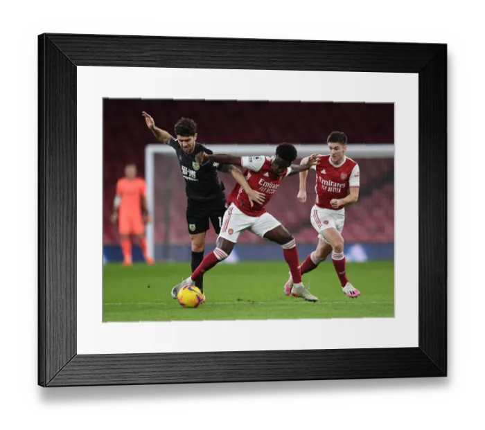 Framed Print : Saka vs Brady: A Premier League Showdown at Emirates Stadium - Arsenal vs Burnley