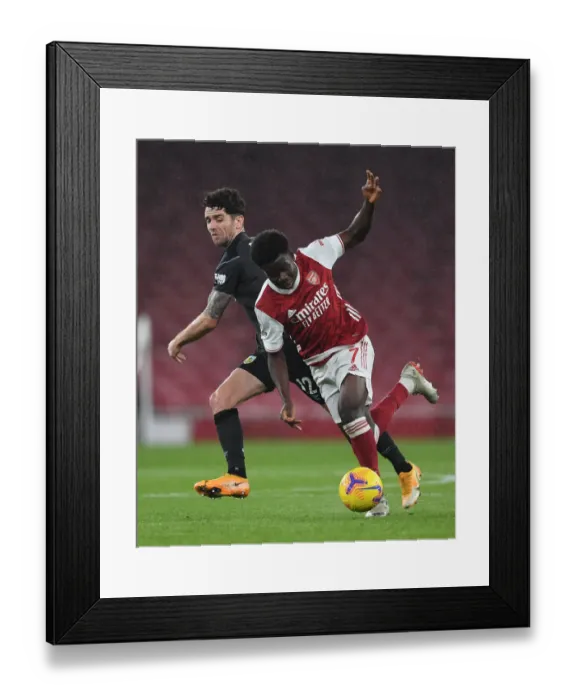 Framed Print : Arsenal's Bukayo Saka Faces Off Against Burnley's Robbie Brady in Premier League Clash Framed Print : Arsenal's Bukayo Saka Faces Off Against Burnley's Robbie Brady in Premier League Clash