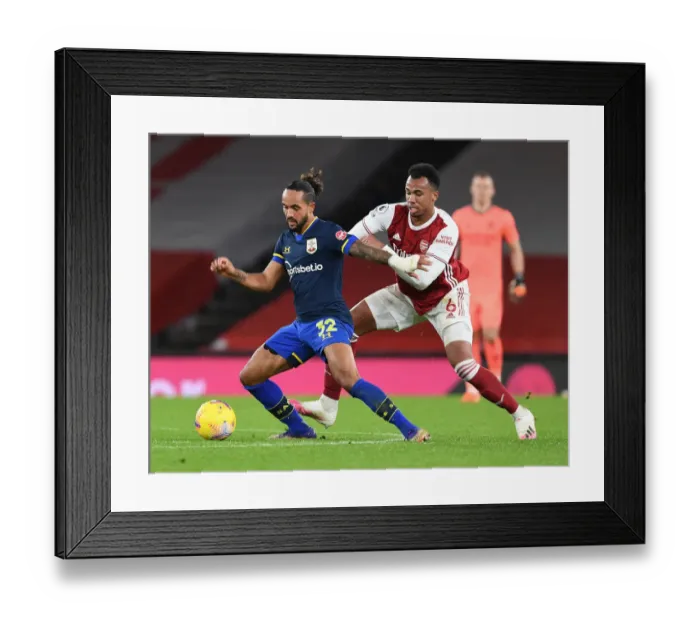 Framed Print : Arsenal Rivals Clash: Gabriel vs Walcott in Empty Emirates Stadium