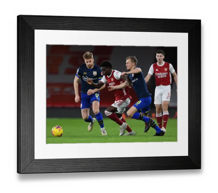 Framed Print : Arsenal's Bukayo Saka Faces Off Against Southampton's Stuart Armstrong and James Ward-Prowse in Premier League Clash Framed Print : Arsenal's Bukayo Saka Faces Off Against Southampton's Stuart Armstrong and James Ward-Prowse in Premier League Clash