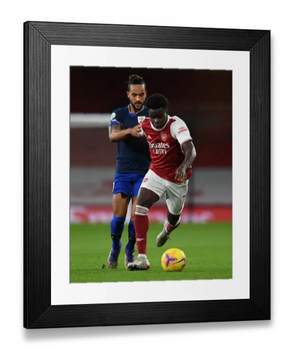 Framed Print : Arsenal vs Southampton: Bukayo Saka vs Theo Walcott Clash in Premier League Showdown Framed Print : Arsenal vs Southampton: Bukayo Saka vs Theo Walcott Clash in Premier League Showdown