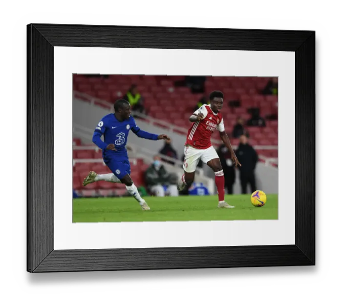 Framed Print : Arsenal's Bukayo Saka Clashes with Chelsea's N'Golo Kante in Premier League Showdown