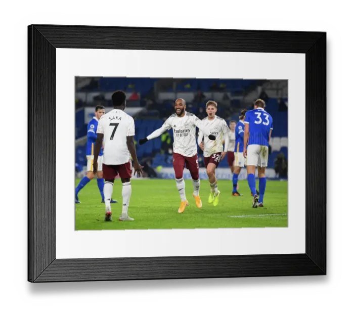 Framed Print : Jubilant Moment: Lacazette and Saka Celebrate Arsenal's Goal Against Brighton & Hove Albion, Premier League 2020-21