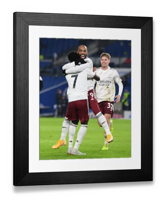 Framed Print : Lacazette and Saka Celebrate Arsenal's Goal Against Brighton & Hove Albion (2020-21)