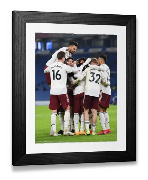 Framed Print : Lacazette Scores: Arsenal Triumphs Over Brighton & Hove Albion in Premier League Clash