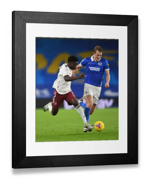 Framed Print : Bukayo Saka Faces Off Against Dan Burn: Brighton & Hove Albion vs. Arsenal, Premier League 2020-21
