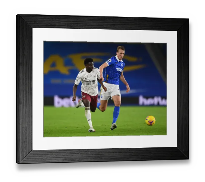 Framed Print : Bukayo Saka vs. Dan Burn: A Fierce Battle – Arsenal's Triumph over Brighton & Hove Albion, Premier League 2020-21