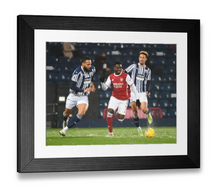 Framed Print : Arsenal's Bukayo Saka Outmaneuvers West Bromwich Albion's Kyle Bartley in Premier League Clash