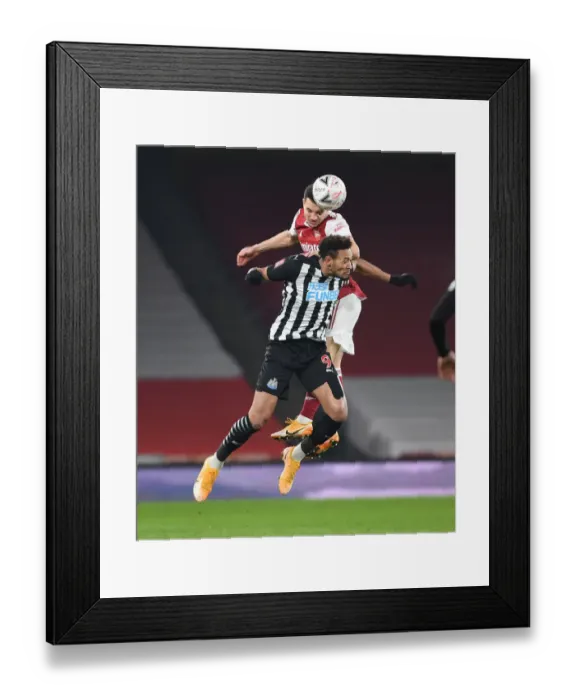 Framed Print : Arsenal's Cedric Soars Above Joelinton in FA Cup Clash: Arsenal vs. Newcastle United (2020-21) Framed Print : Arsenal's Cedric Soars Above Joelinton in FA Cup Clash: Arsenal vs. Newcastle United (2020-21)