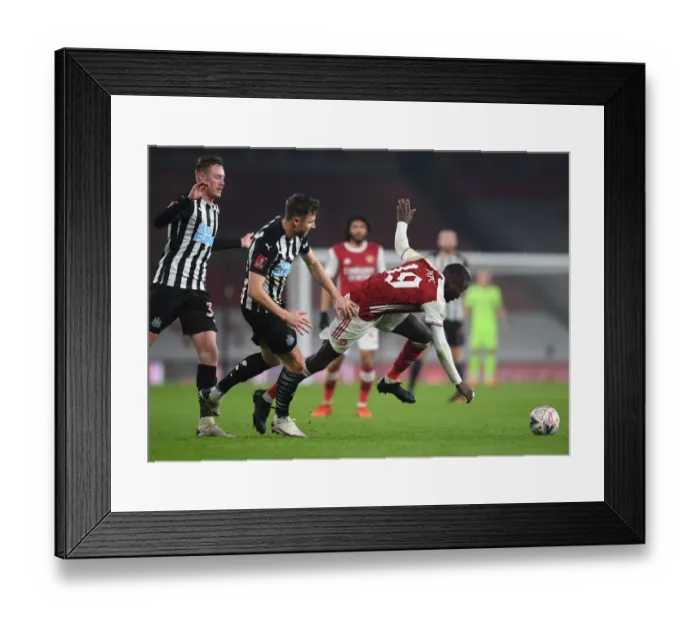 Framed Print : Arsenal's Nicolas Pepe Faces Off Against Newcastle's Paul Dummett in FA Cup Clash
