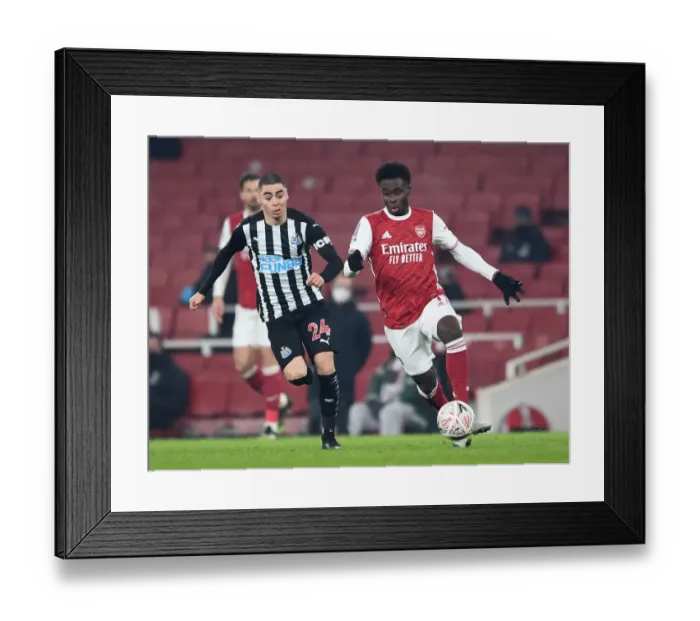 Framed Print : Arsenal's Bukayo Saka Clashes with Newcastle's Miguel Almiron in FA Cup Third Round