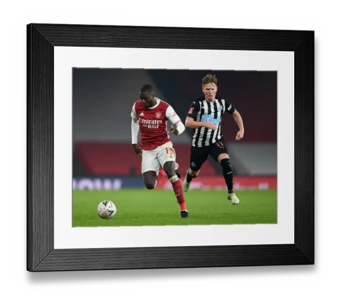 Framed Print : Arsenal's Nicolas Pepe Clashes with Newcastle's Matt Ritchie in FA Cup Third Round Framed Print : Arsenal's Nicolas Pepe Clashes with Newcastle's Matt Ritchie in FA Cup Third Round