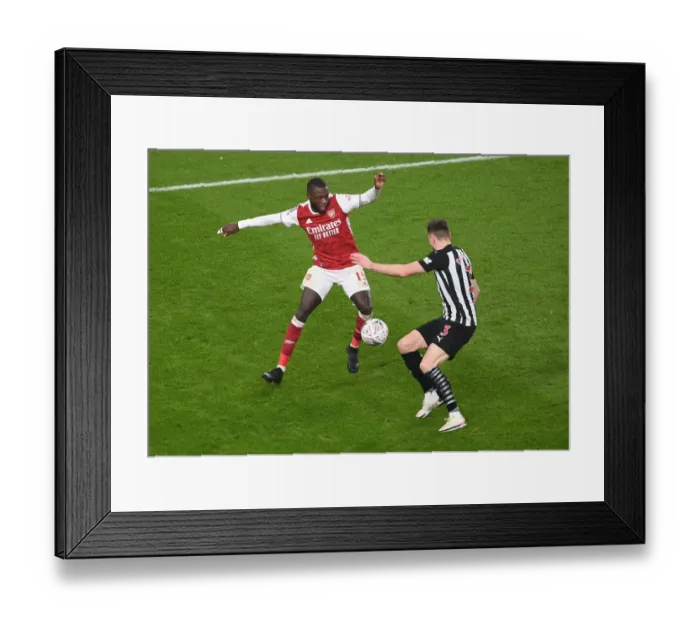 Framed Print : Arsenal's Nicolas Pepe Clashes with Newcastle's Paul Dummett in FA Cup Third Round