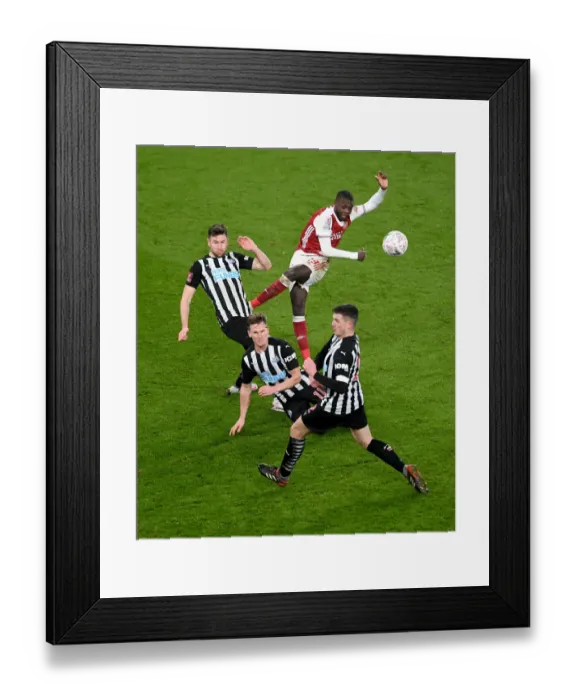 Framed Print : Arsenal's Nicolas Pepe Faces Pressure from Newcastle's Defense in FA Cup Clash