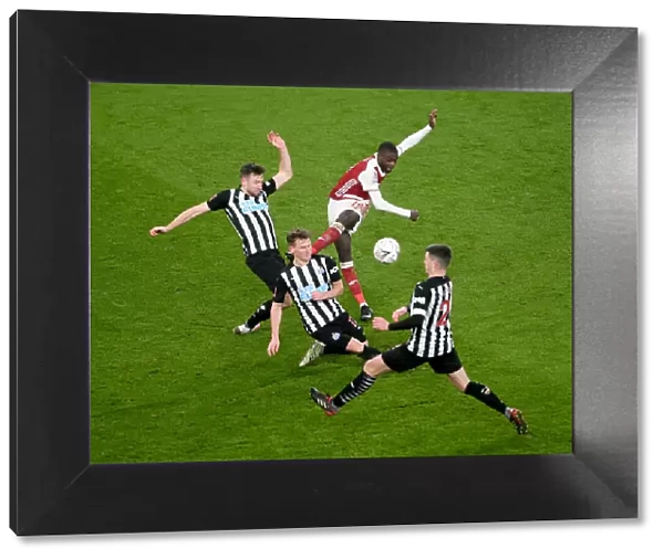 Intense Defensive Pressure: Arsenal's Nicolas Pepe Faces Off Against Newcastle's Triple Threat in FA Cup Clash