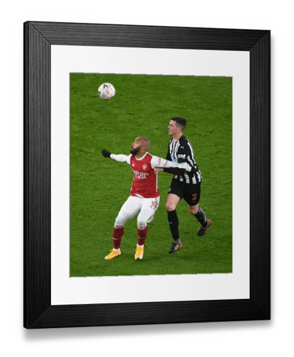 Framed Print : Arsenal's Lacazette Faces Off Against Newcastle's Clark in FA Cup Clash Framed Print : Arsenal's Lacazette Faces Off Against Newcastle's Clark in FA Cup Clash
