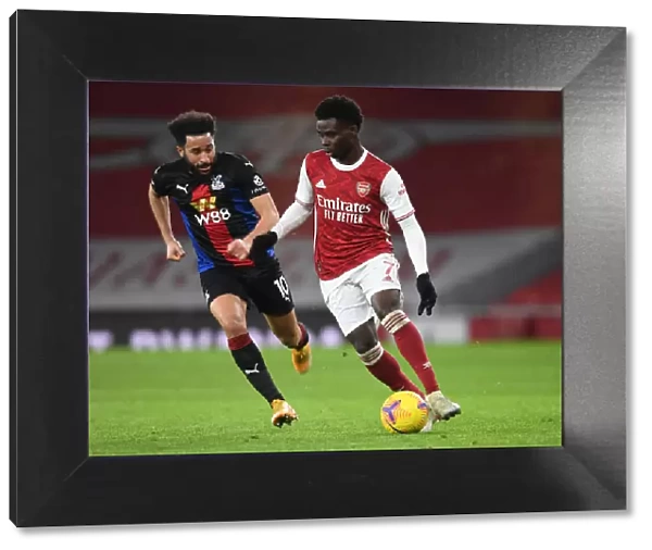 Arsenal vs Crystal Palace: Bukayo Saka in Action at Emirates Stadium Amidst Empty Seats (2020-21)