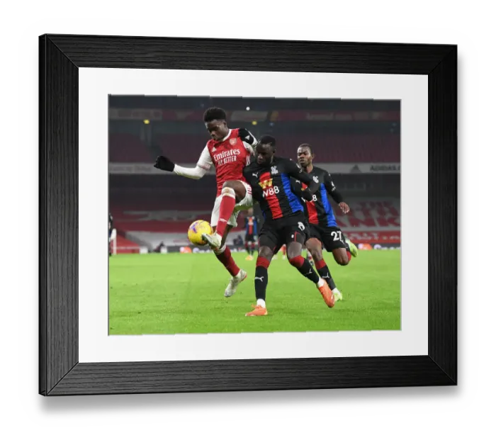 Framed Print : Arsenal vs. Crystal Palace: Bukayo Saka vs. Cheikhou Kouyate in Premier League Clash Amidst Empty Emirates Stadium