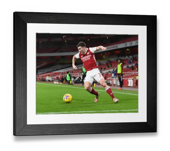 Framed Print : Arsenal's Kieran Tierney in Action at Empty Emirates Stadium Against Newcastle United (2020-21)