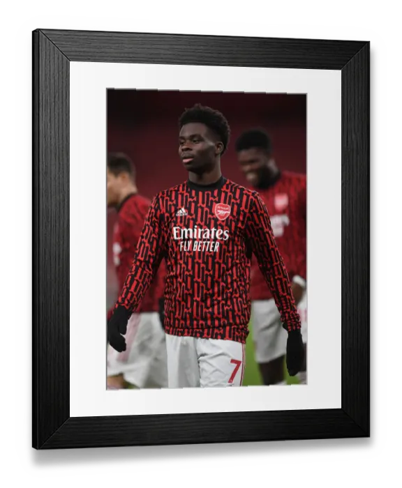 Framed Print : Arsenal's Bukayo Saka Prepares for Newcastle United Clash at Empty Emirates Stadium (Arsenal v Newcastle United, 2021) Framed Print : Arsenal's Bukayo Saka Prepares for Newcastle United Clash at Empty Emirates Stadium (Arsenal v Newcastle United, 2021)
