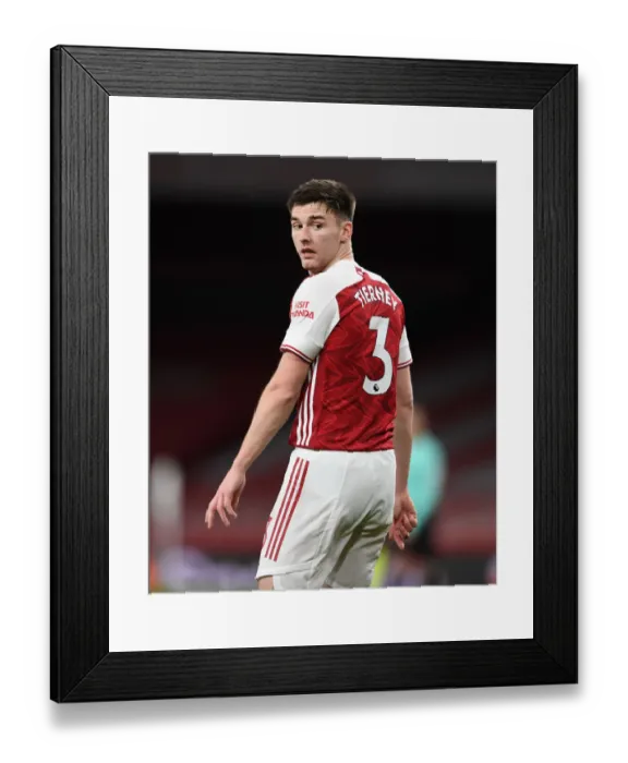 Framed Print : Arsenal's Kieran Tierney in Action Against Newcastle United at Empty Emirates Stadium (2020-21)