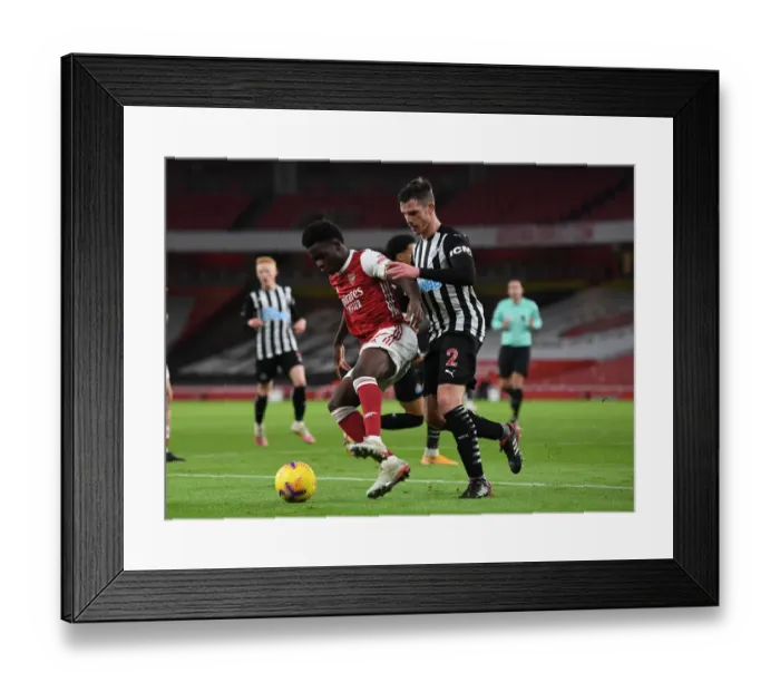 Framed Print : Arsenal vs Newcastle United: Bukayo Saka Faces Off Against Ciaran Clark Amid Empty Emirates Stadium (Premier League 2020-21)