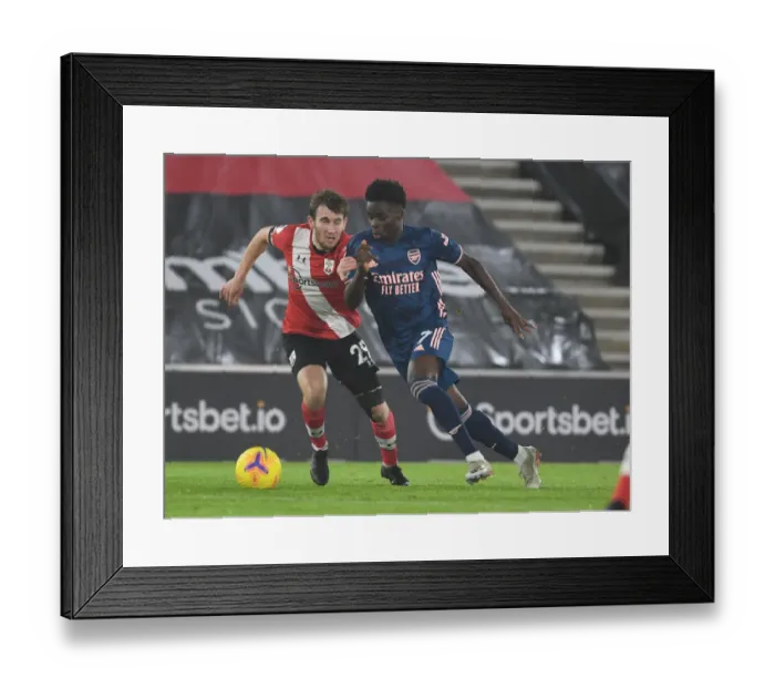 Framed Print : Arsenal's Bukayo Saka Outmaneuvers Southampton's Jake Vokins in Empty St. Mary's Stadium - Southampton vs Arsenal, Premier League 2020-21 Framed Print : Arsenal's Bukayo Saka Outmaneuvers Southampton's Jake Vokins in Empty St. Mary's Stadium - Southampton vs Arsenal, Premier League 2020-21