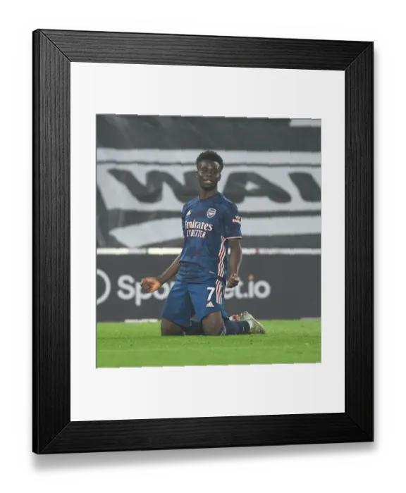 Framed Print : Saka Scores: Arsenal's 2-0 Victory Over Southampton Amidst Empty St. Mary's Stadium (2020-21)