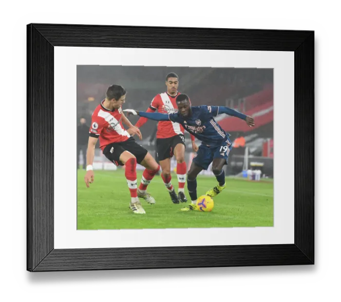 Framed Print : Pepe vs Bednarek: Empty St Mary's Showdown - Arsenal's Nicolas Pepe Clashes with Southampton's Jan Bednarek in Premier League's Empty Stadiums (2021)