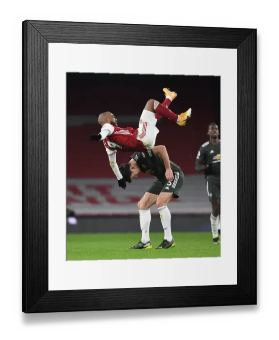 Framed Print : Lacazette vs Maguire: Empty Battle in Arsenal vs Manchester United Premier League Clash Amidst Coronavirus Restrictions Framed Print : Lacazette vs Maguire: Empty Battle in Arsenal vs Manchester United Premier League Clash Amidst Coronavirus Restrictions