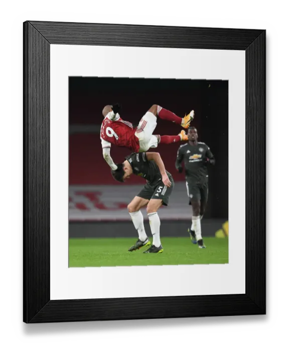 Framed Print : LONDON, ENGLAND - JANUARY 30: Alex Lacazette of Arsenal challenged by Harry Maguire of Man United during the Premier Framed Print : LONDON, ENGLAND - JANUARY 30: Alex Lacazette of Arsenal challenged by Harry Maguire of Man United during the Premier