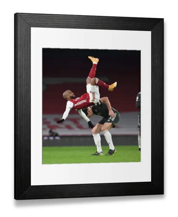Framed Print : Arsenal vs Manchester United: Lacazette vs Maguire - Premier League Showdown Amidst Empty Seats (January 2021)