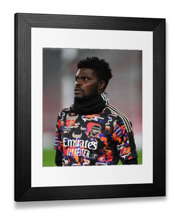 Framed Print : Thomas Partey's Focused Pre-Match Routine: Arsenal vs Manchester United at Empty Emirates Stadium (Premier League 2020-21)