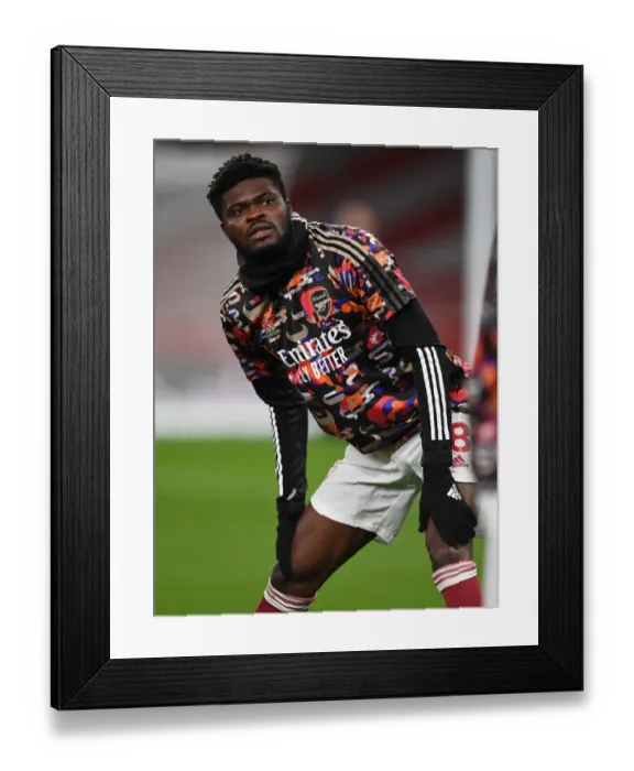 Framed Print : Thomas Partey: Arsenal's Lone Warrior in Empty Emirates Against Manchester United (2021) Framed Print : Thomas Partey: Arsenal's Lone Warrior in Empty Emirates Against Manchester United (2021)