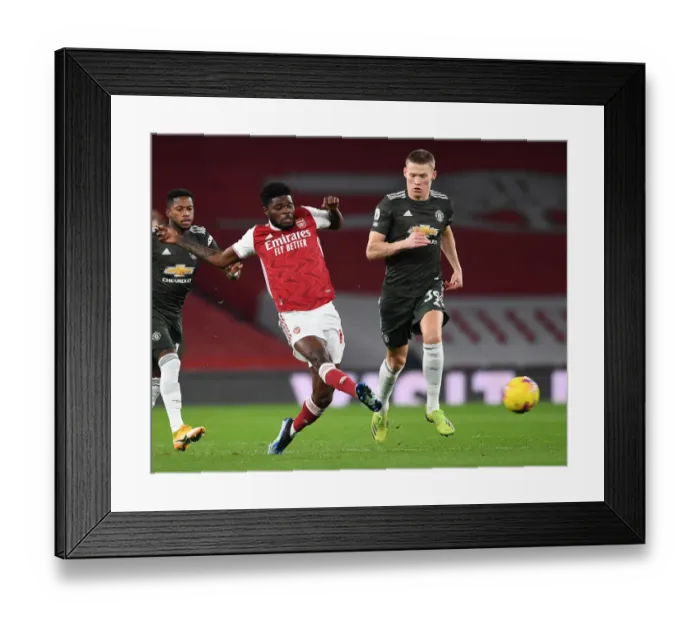 Framed Print : Arsenal vs Manchester United: Thomas Partey Faces Off Against Scott McTominay in Empty Emirates Stadium, Premier League 2021 Framed Print : Arsenal vs Manchester United: Thomas Partey Faces Off Against Scott McTominay in Empty Emirates Stadium, Premier League 2021